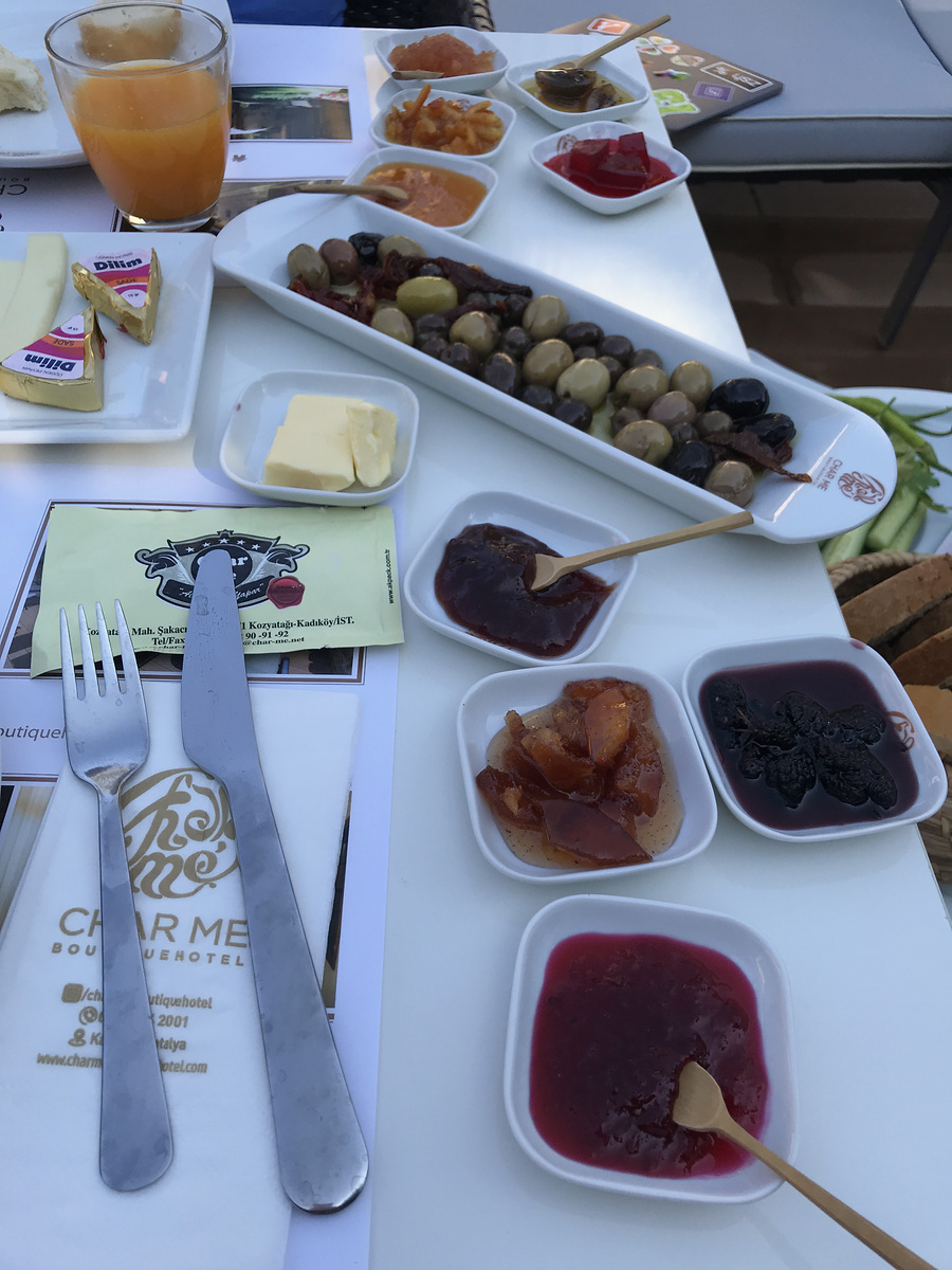 Olives, cheeses, preserves and orange juice at breakfast at Char Me Boutique Hotel.