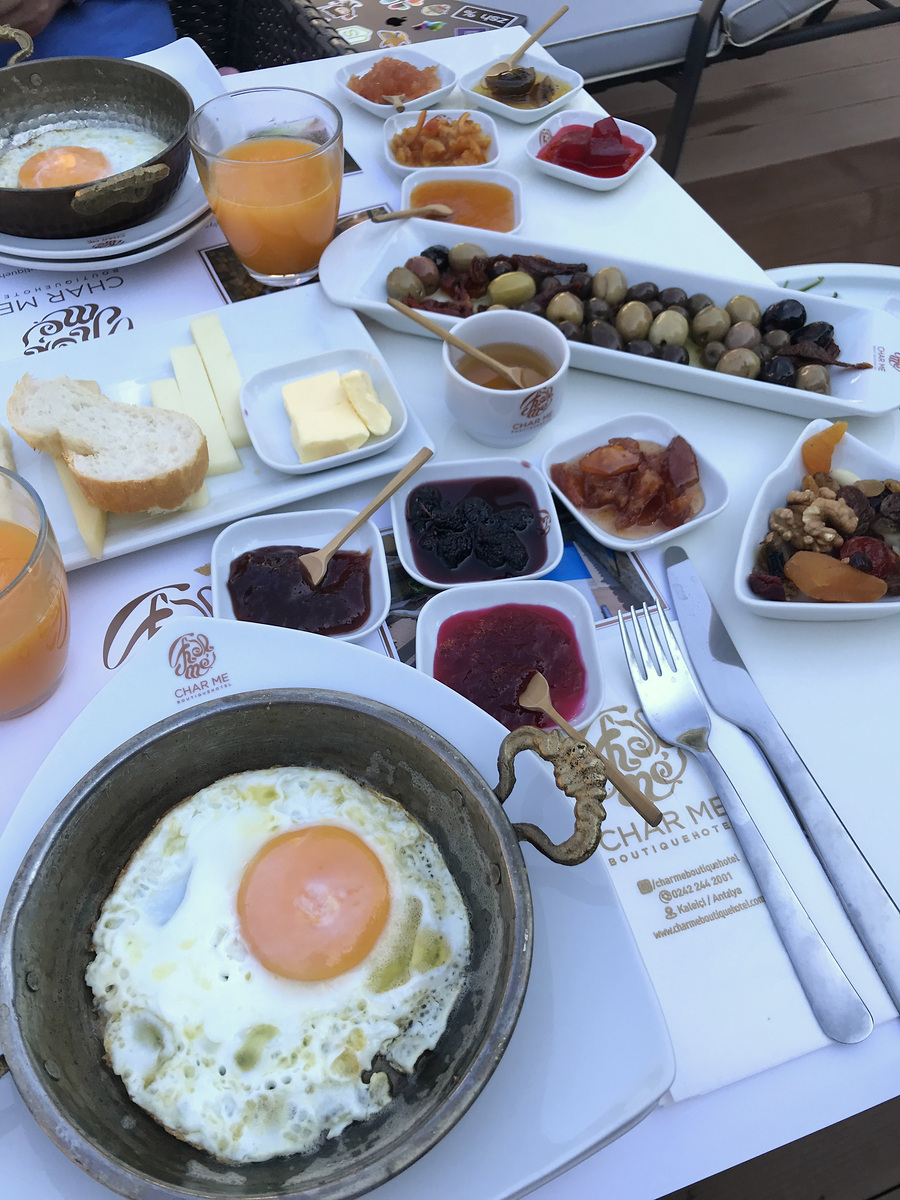 Eggs in metal pans, bread, olives, cheeses, preserves and tea at Char Me Boutique Hotel.