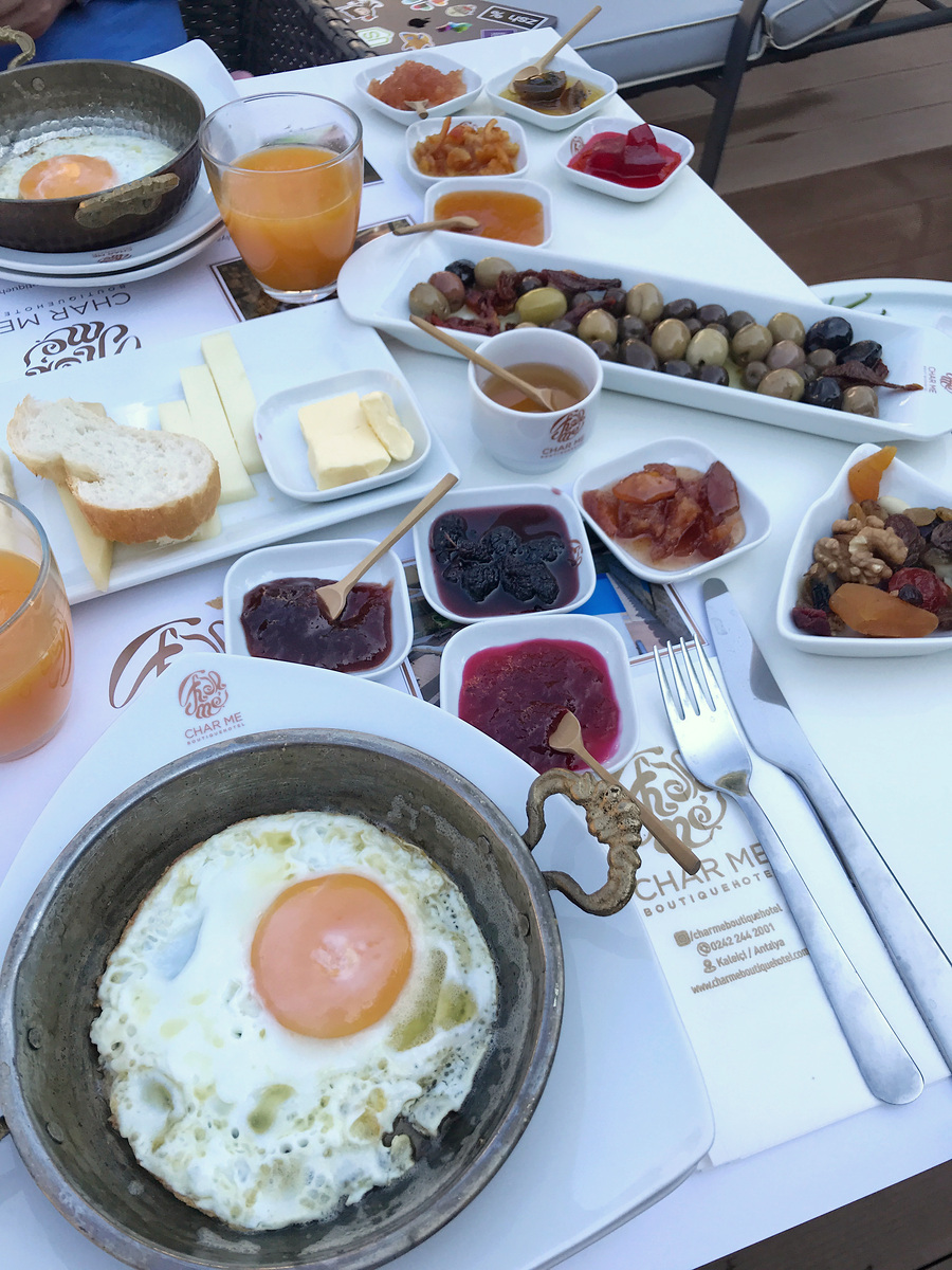 Eggs in metal pans, bread, olives, cheeses, preserves and tea at Char Me Boutique Hotel.