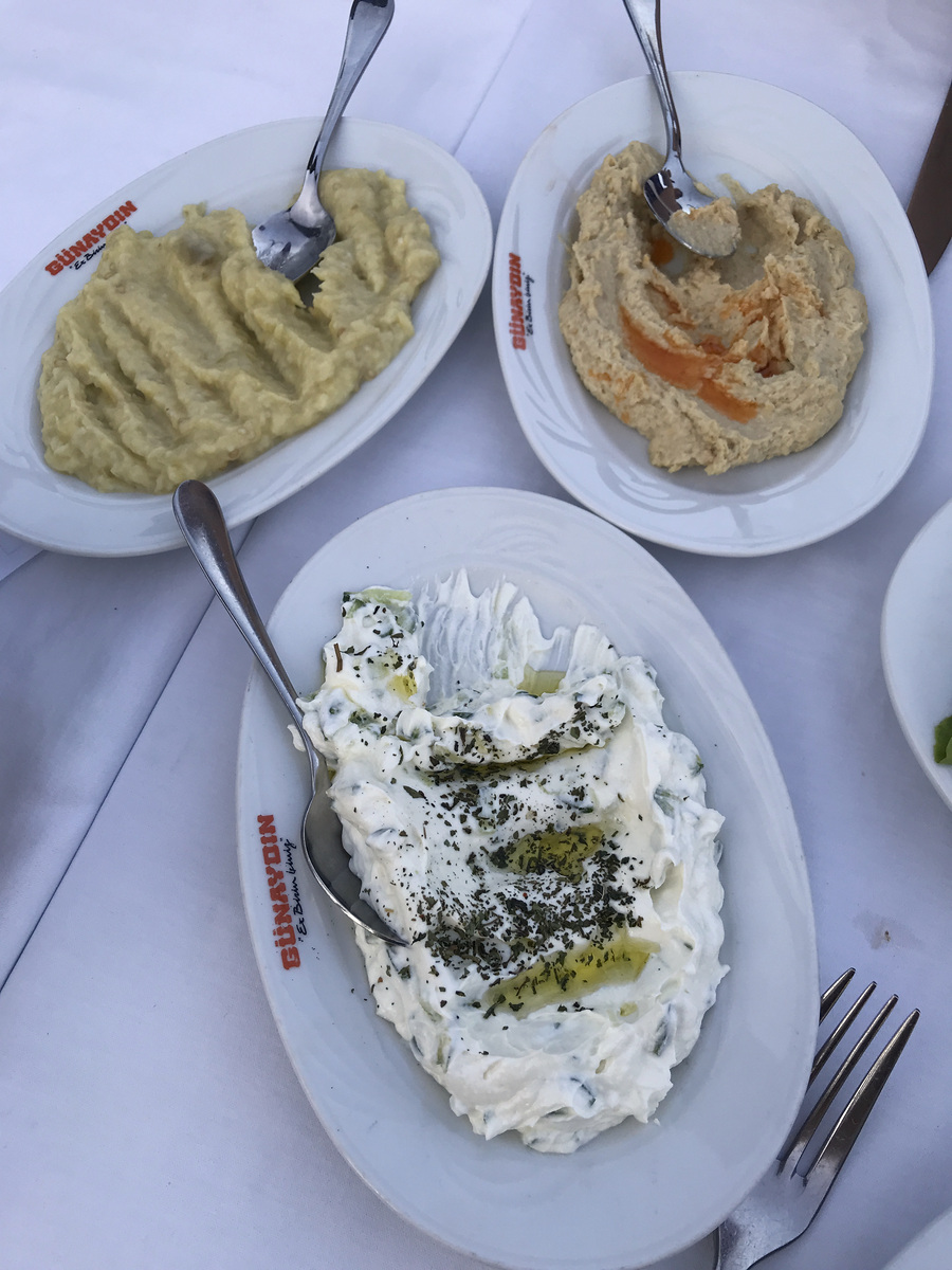 Three plates of meze on a white tablecloth at Günaydın in Lara, Antalya.