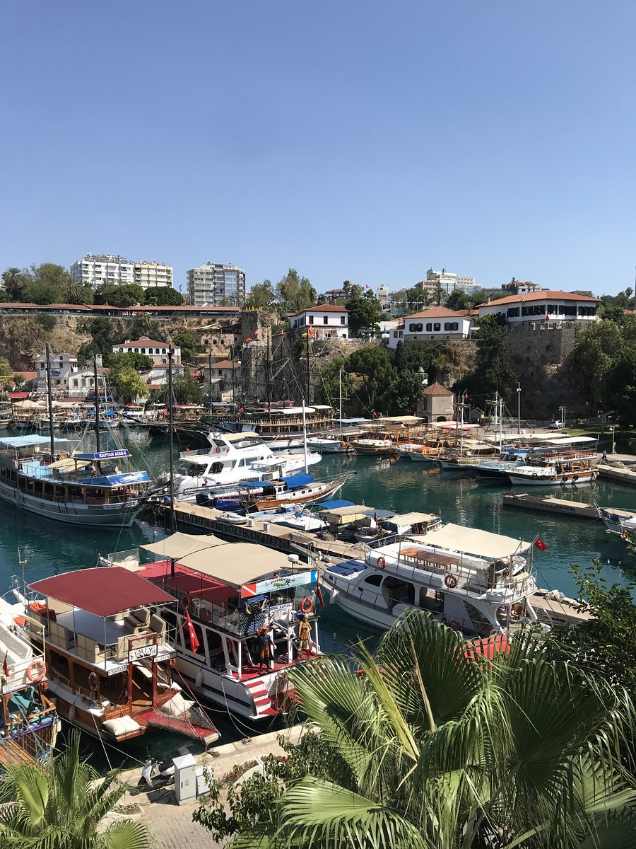 Boats and waterfront buildings around Antalya’s old harbour, seen from above.