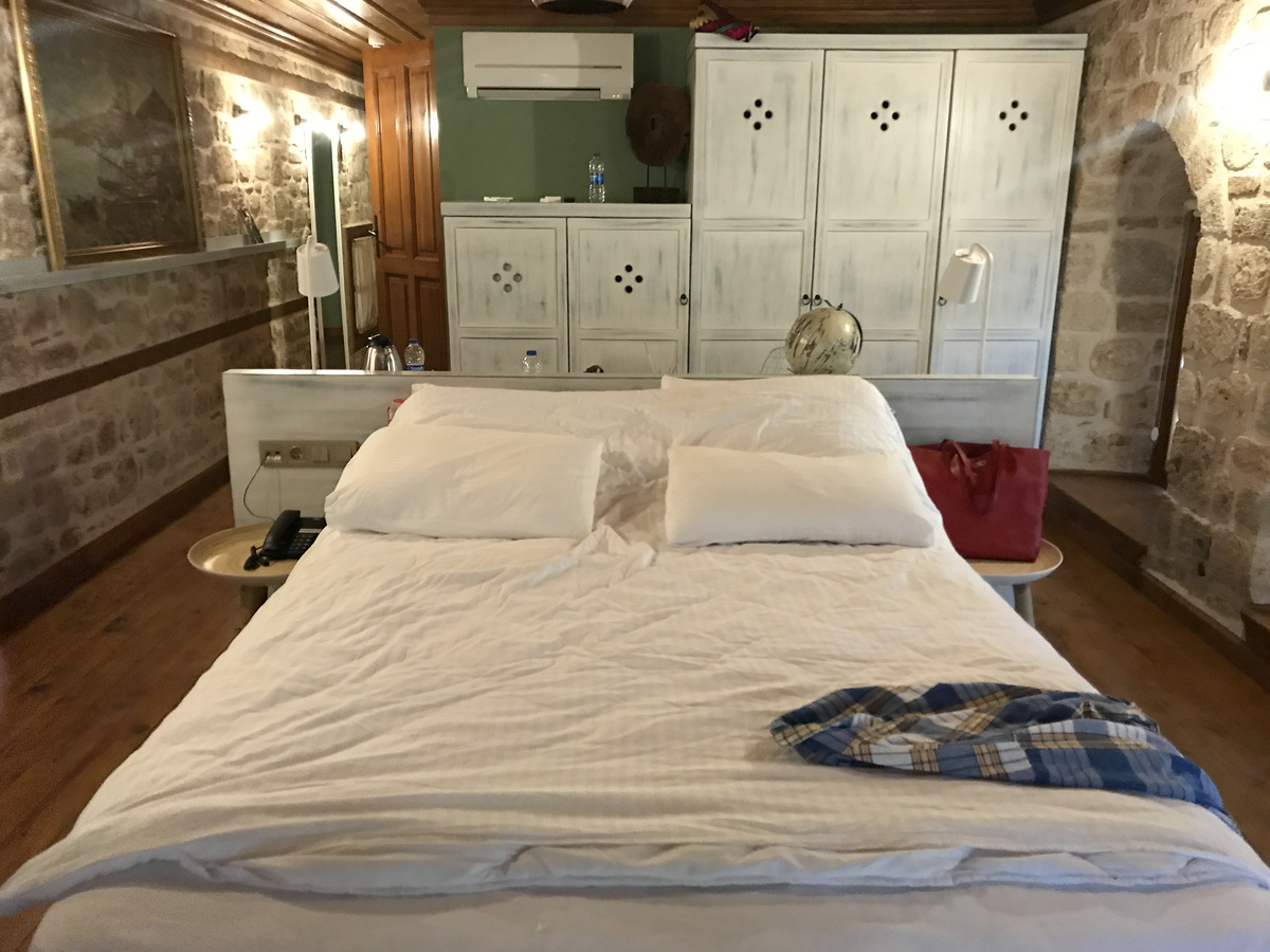 Our Char Me Deluxe Room, showing the bed and storage behind it.