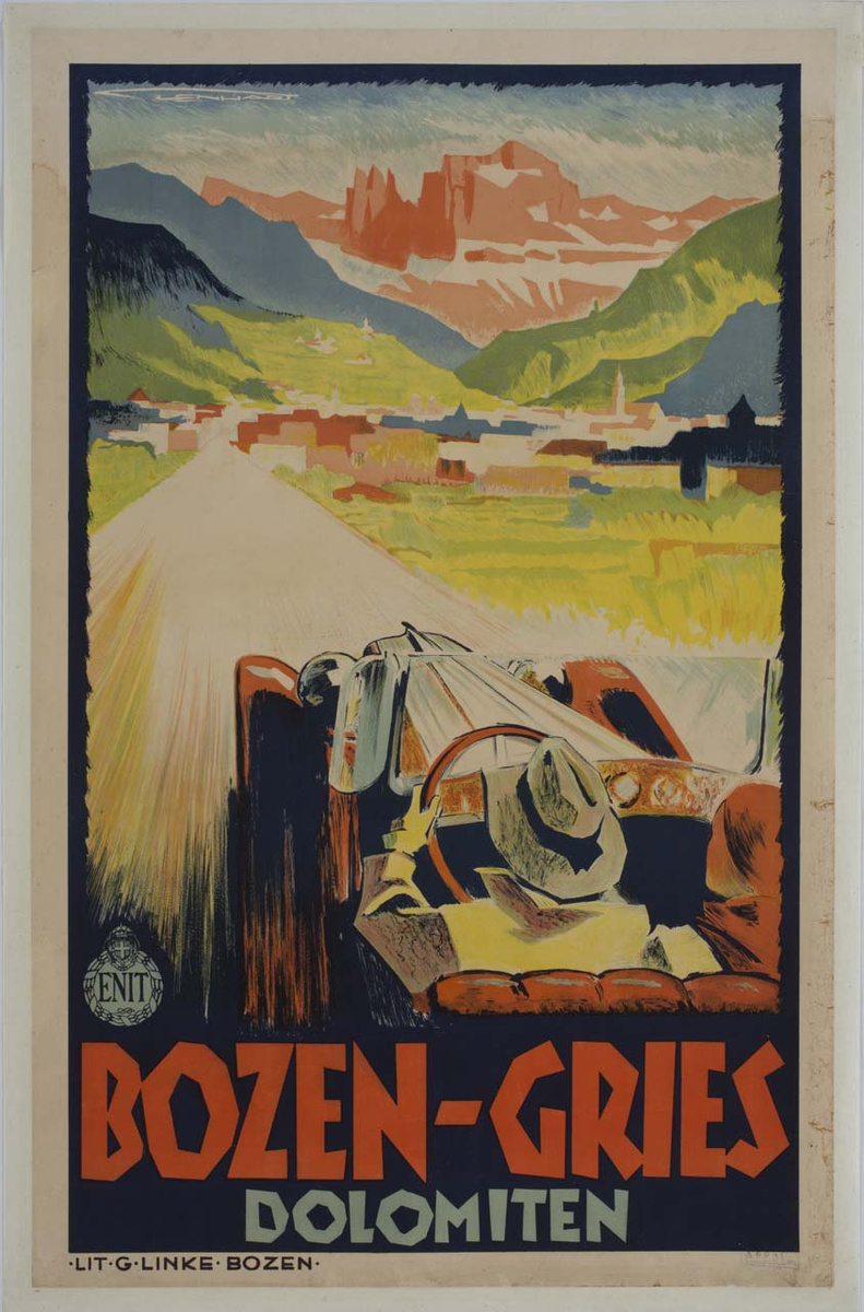 A 1934 colour poster showing a red convertible approaching Bolzano beneath the Dolomites, with the lettering “Bozen-Gries Dolomiten”.