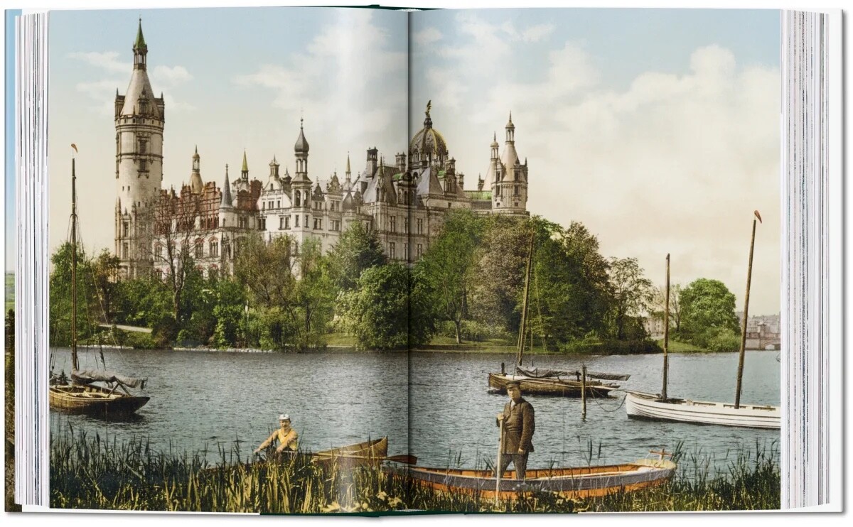 An open spread from Germany 1900, showing a turreted castle on a lake with men in rowing boats among the reeds.