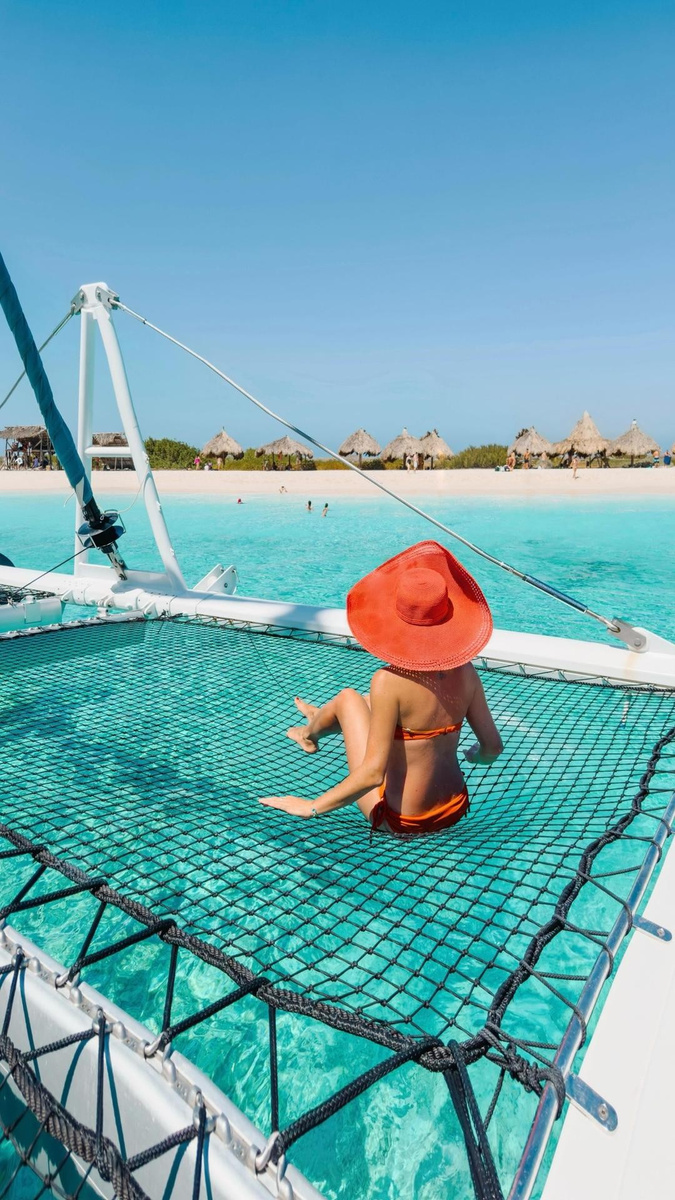Olga seated on a catamaran net facing Klein Curaçao’s beach.