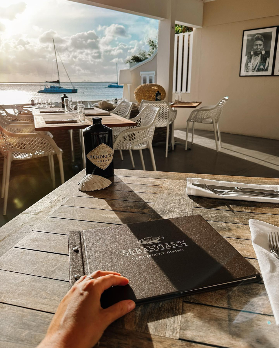 A Sebastian’s menu on a set table overlooking boats and the sea.
