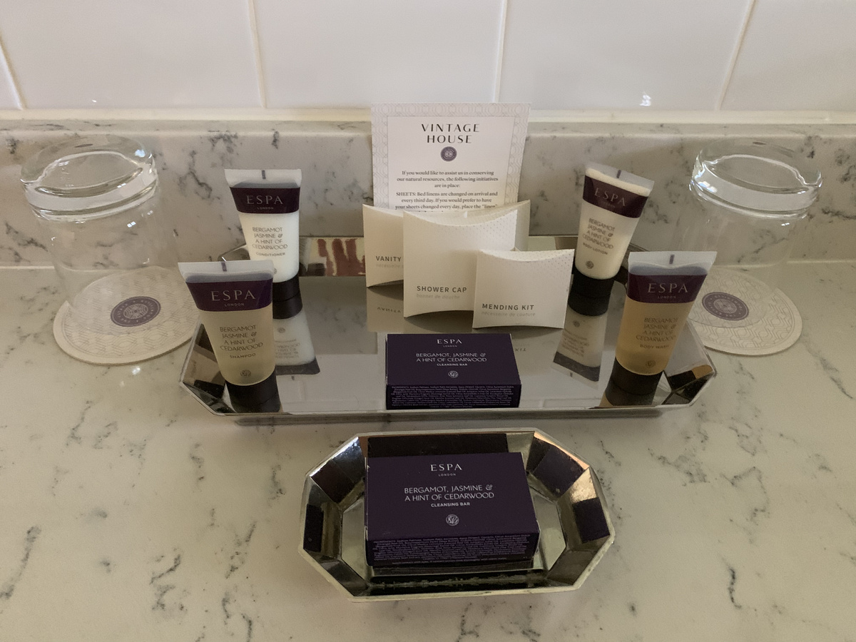 ESPA toiletries and Vintage House amenity packets on a marble bathroom counter.