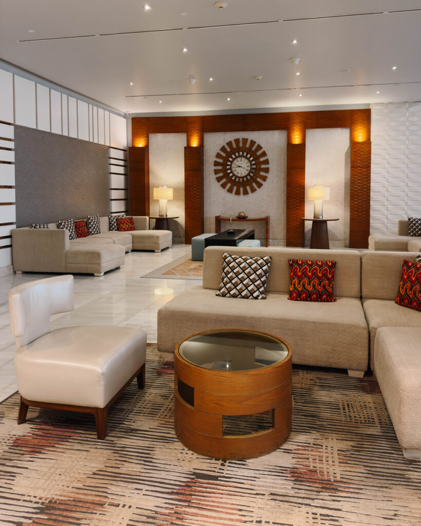 Sofas, armchairs and a large clock in the lobby of Waldorf Astoria Panama.