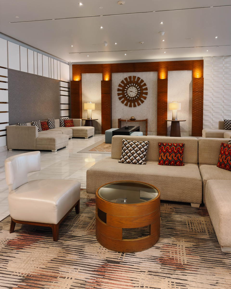 Sofas, armchairs and a large clock in the lobby of Waldorf Astoria Panama.