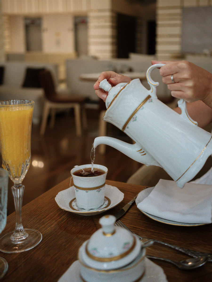 Tea being poured from a white teapot into a cup at Waldorf Astoria Panama.