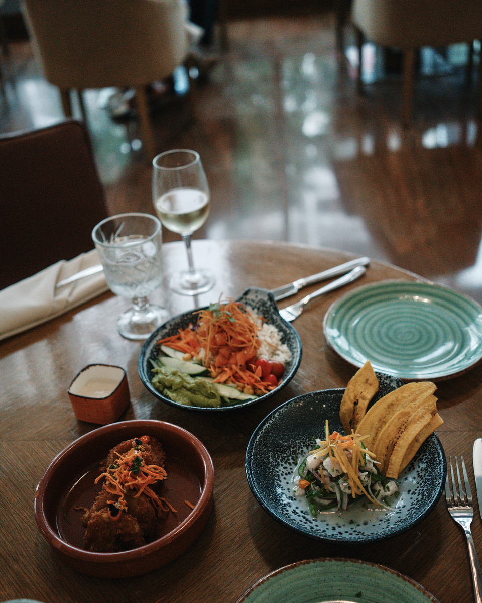 Small plates and a rice bowl on a wooden table at Waldorf Astoria Panama.